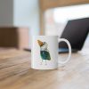 White ceramic coffee mug with a watercolor painting of a whimsical crow called Squawk mug is on a wooden table