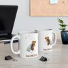 two white ceramic coffee mugs with a watercolor painting of a startled fruit fly the mugs are on a table