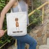girl with a white canvas tote bag with a watercolor painting of a whimsical ant