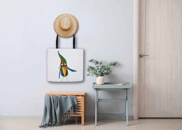 White Tote Bag with watercolor painting of a whimsical crow called Bubba the bag is haning on a wall
