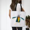 girl with a White polyester tote bag featuring a whimsical watercolor painting of a crow