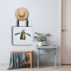 White polyester tote bag featuring a whimsical watercolor painting of a crow the bag is hanging on a wall