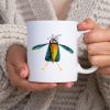 White 11 oz ceramic coffee mug with a whimsical watercolor illustration of a crow