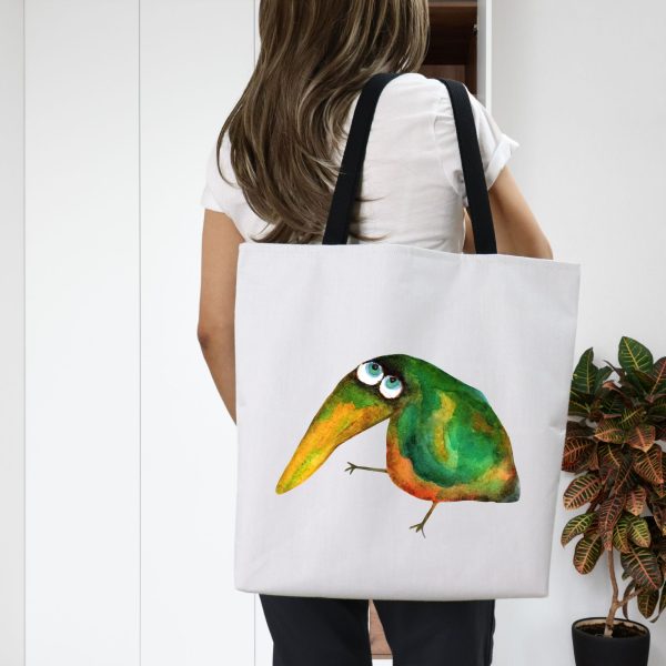 Girl with a white polyester tote bag featuring a watercolor illustration of a whimsical crow