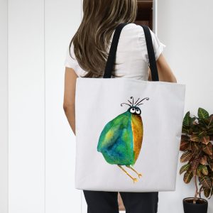 Girl with a white polyester tote bag featuring a watercolor illustration of a whimsical crow