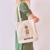 girl with a white canvas tote bag with a watercolor painting of a whimsical ant
