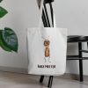 white canvas tote bag with a watercolor painting of a whimsical ant bag is hanging on a chair