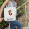 girl with a white canvas tote bag with a watercolor painting of a whimsical cockroach
