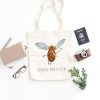 white canvas tote bag with a watercolor painting of a whimsical mosquito the bag is on the floor