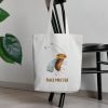 white canvas tote bag with a whimsical watercolor painting of a bug bag is haning on a chair