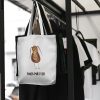 white canvas tote bag with a watercolor painting of a whimsical cockroach