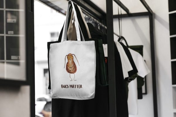 white canvas tote bag with a watercolor painting of a whimsical cockroach
